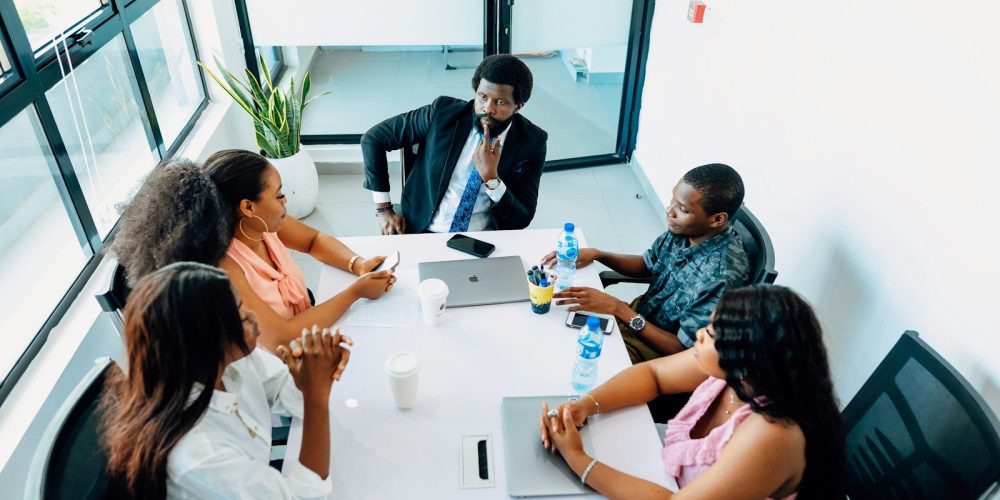 A group of people sitting around a white table